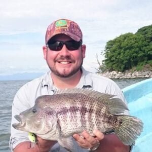 tour guide holding a fish